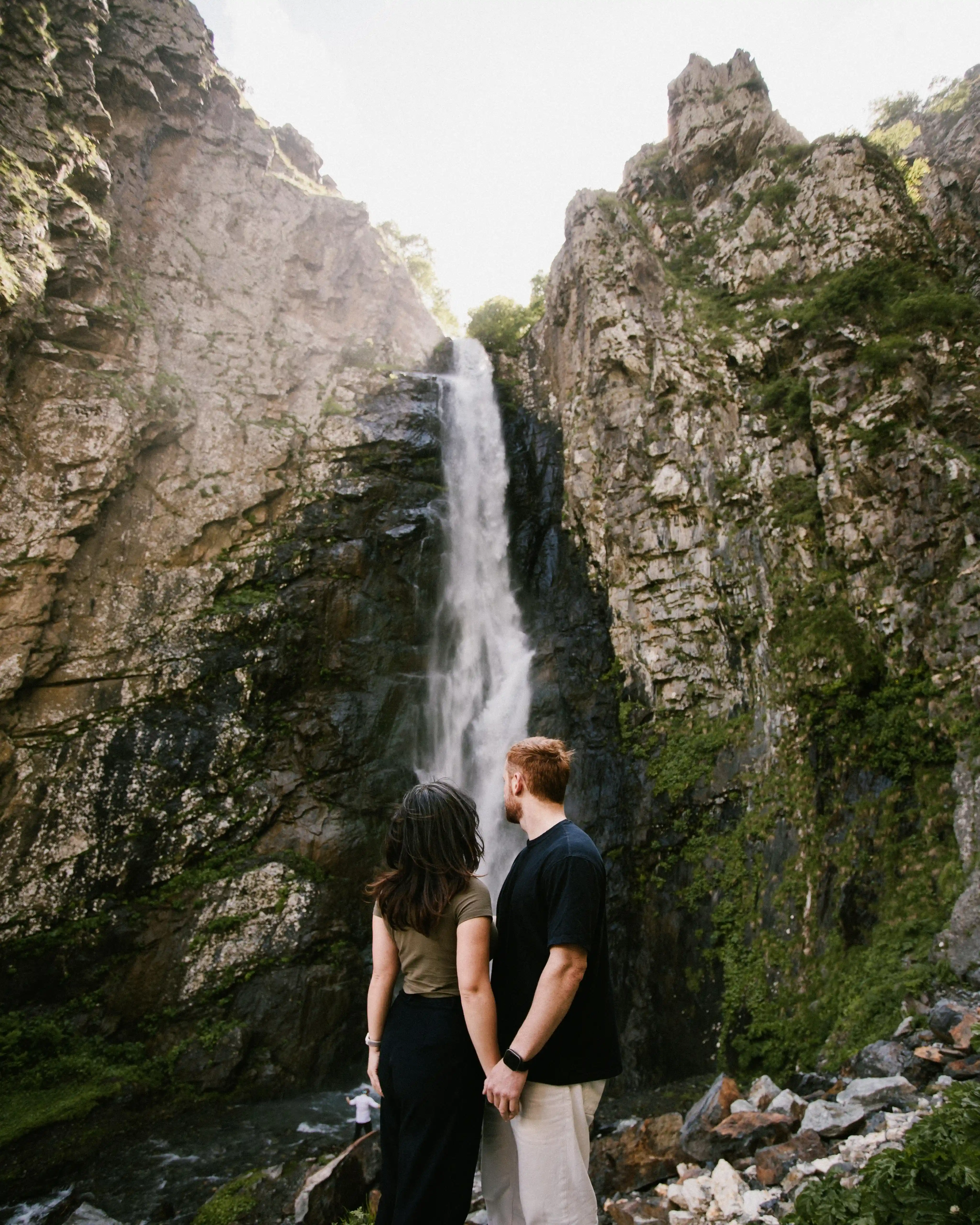 Hikers looking at waterfall